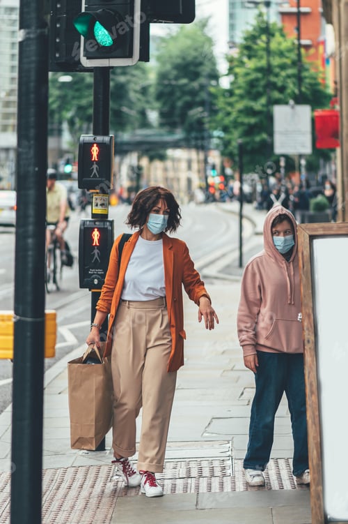 Preview: Woman and Teen on the Sidewalk Wearing Masks