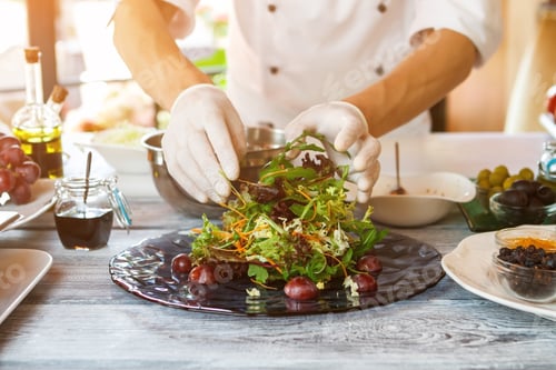 Preview: Hands of cook making salad