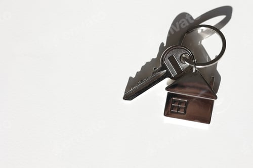 Preview: Key and metal house shaped keychain arrangement on white background with shadow. Business