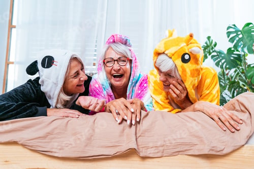 Preview: Beautiful senior women having funny pajama party at home