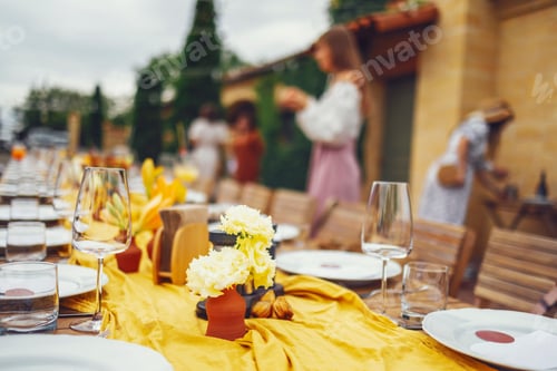 Preview: Banquet. Chairs and a table for guests, decorated with candles, are served with cutlery and crockery