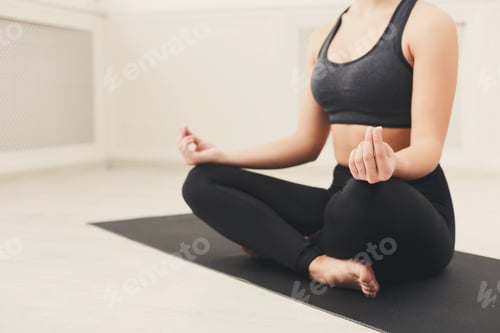 Preview: Young woman in yoga class, relax meditation pose