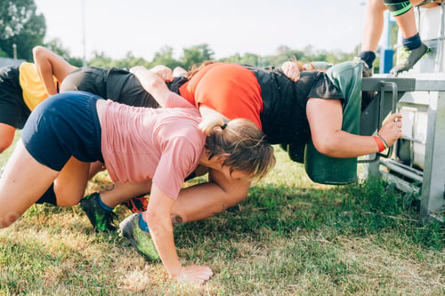 Preview: A group of people competing in an outdoor obstacle course race