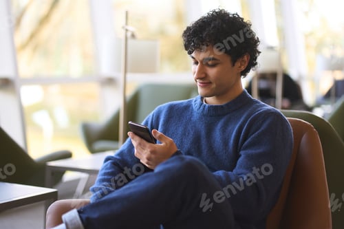 Preview: Young Hispanic man using mobile phone, checks social media content, messages. Technology and people