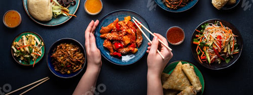 Preview: Set of Chinese dishes on table, female hands holding chopsticks