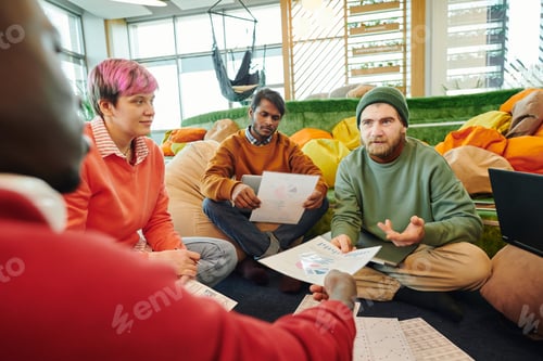 Preview: Group of young intercultural financial managers in casualwear discussing papers