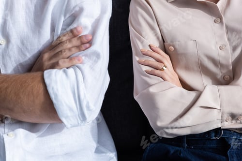 Preview: partial view of woman and man with crossed arms
