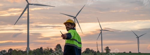 Preview: Service engineers checking system of windmill with tablet. Wind turbines generate electricity.