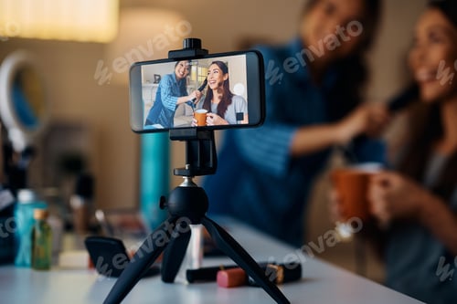 Preview: Happy women having fun while recording beauty vlog at home.