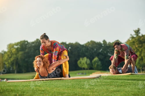 Preview: Therapists performing thai massage outdoor.