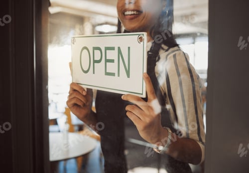 Preview: Closeup on hands of business owner hanging open sign. Businesswoman hanging signage in her store do