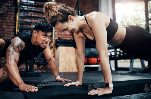 Preview: Shot of a young woman working out with her personal trainer