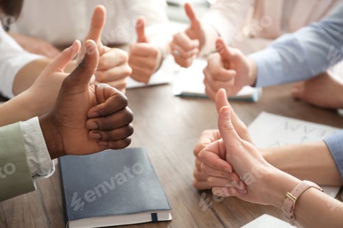 Preview: People showing thumbs up at table, closeup of hands. Unity concept