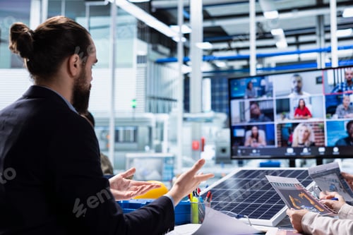 Preview: Photovoltaics factory managers look over schematics during teleconference