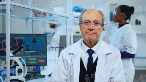 Preview: Portrait of senior experienced scientist man smiling at camera
