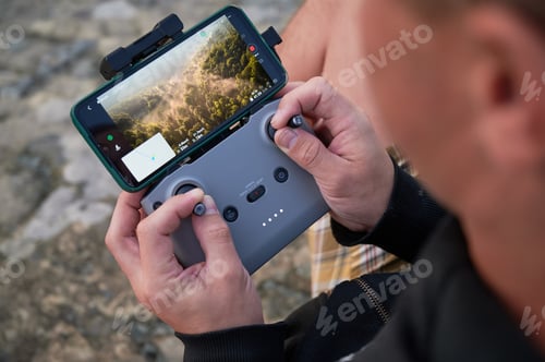 Adult Man Operating Drone Controller Outdoors