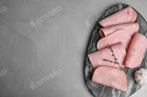 Preview: Tasty ham served on light grey table, top view. Space for text
