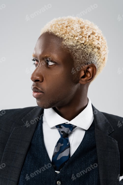 Preview: stylish african american businessman in suit looking away isolated on grey