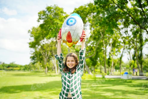 Preview: Portrait of red hair kid in pilot costume holding bolloon running in summer field