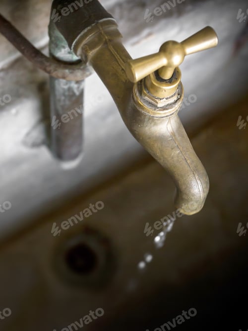 Preview: Water shortage concept. Old leaky dripping faucet.
