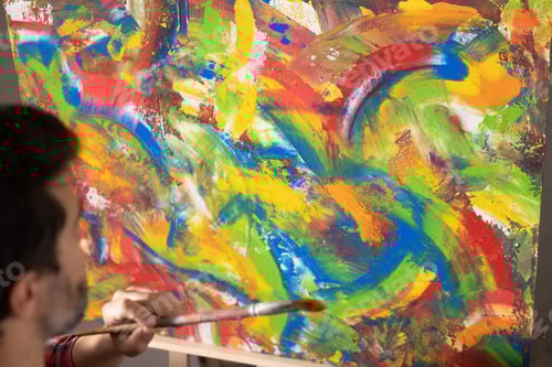 Preview: Male artist working on painting. Man artist painter in creative studio