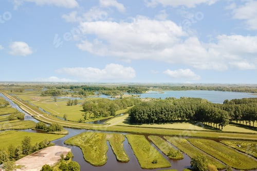 Preview: an aerial view of a field with waterways and trees