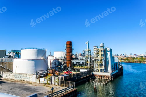 Preview: Elevated view of industrial biofuel plant on river waterfront