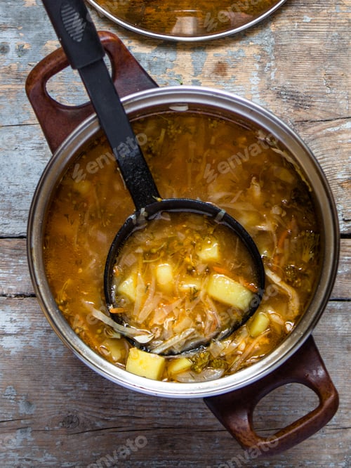 Preview: First Dish In A Saucepan With A Ladle - Tomato Soup With Cabbage, Broccoli And Other Vegetables