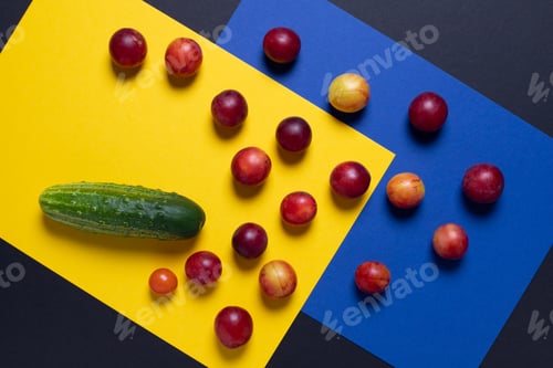 Preview: Creative of colorful tomato and cucumber, Creative foods. Black and yellow background for design