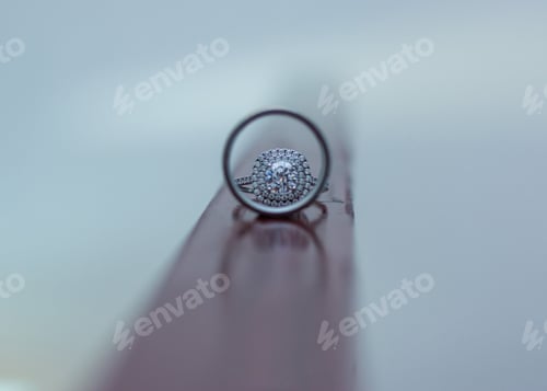 Preview: Closeup of an engagement ring under magnifying glass
