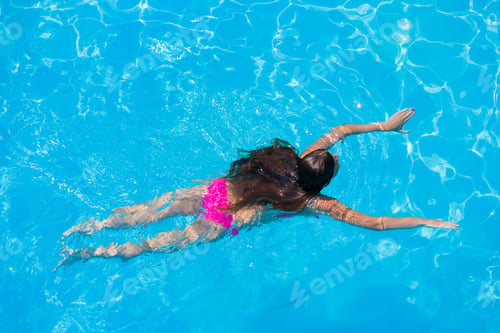 Preview: A girl is relaxing in a swimming pool