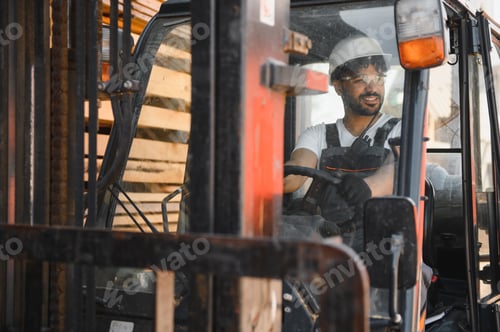 Preview: Warehouse worker driving forklift carrying lumber in timber warehouse