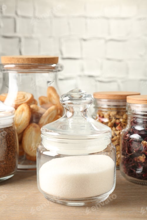 Preview: Glass jars with different products on wooden table, closeup