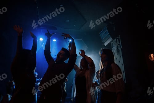 Preview: Group of people that enjoying dancing in the nightclub with beautiful lightings