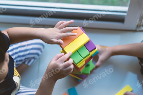 Preview: Kids playing with wooden block making a tower