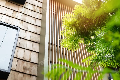Preview: home with wooden wall wooden slats and green tree for cooling sunshade and saving energy
