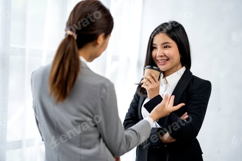 Preview: Two Asian businesswoman colleagues drink coffee. and discuss new marketing business strategy project