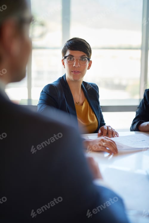 Preview: Exchanging information. Shot of three corporate businesspeople working in the boardroom.