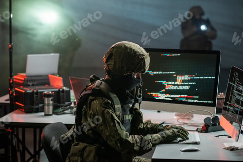 Preview: Gloved cyber criminal in camouflage attire decoding information