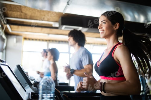 Preview: Group of young people running on treadmill in gym