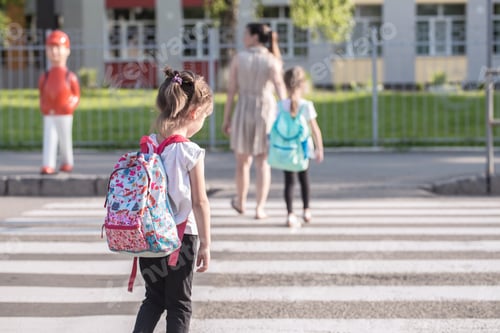 Preview: Girl kids, elementary students, carrying backpacks going to class