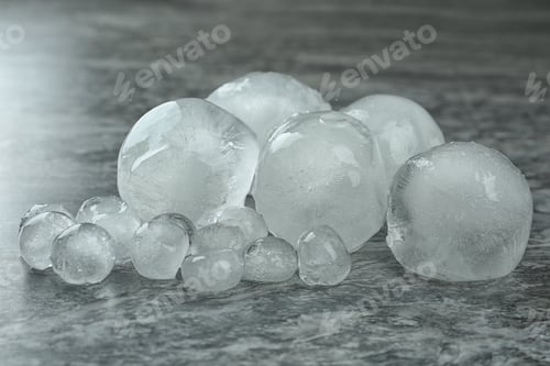 Preview: Many frozen ice balls on grey marble table