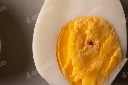 Preview: Directly above close-up view of fresh boiled white egg with yellow yolk
