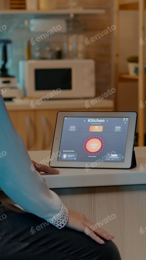 Preview: Woman looking at tablet in house with automation lighting system