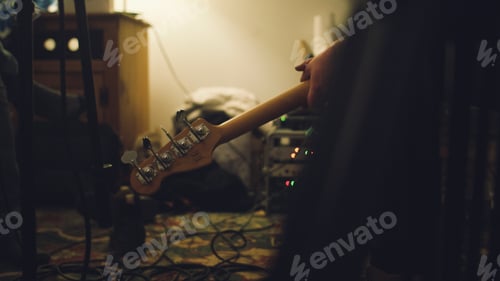 Preview: Bass guitar dead in a room with a hand.