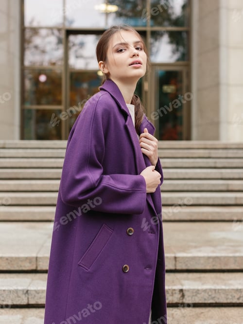 Preview: Happy business woman walking at beautiful autumn city street wearing colorful scarf and warm coat