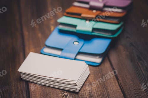 Preview: multicolored business card holders on a wooden background and a pack of white paper Copy Space