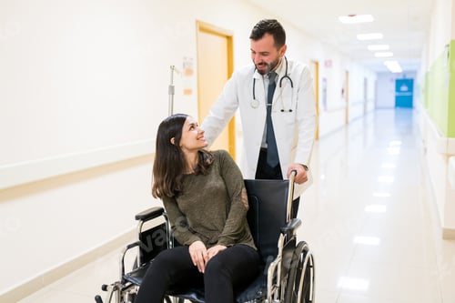 Preview: Medical Professional With Woman On Wheelchair At Hospital