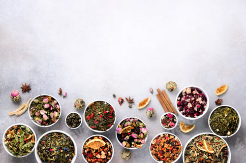 Preview: Assortment of dry tea in white bowls. Tea types backgound: green, black, floral, herbal, mint