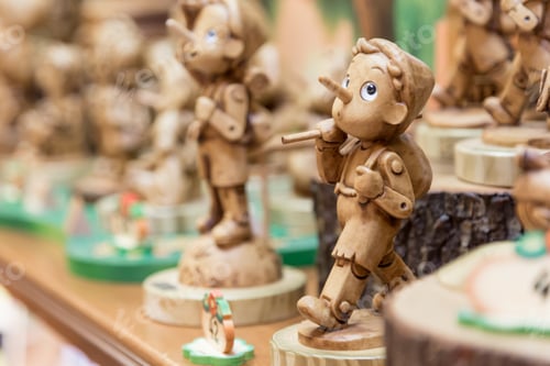 Preview: wooden boy Pinocchio from Carlo Collodi's fairy tale in the window in the souvenir shop in Rome